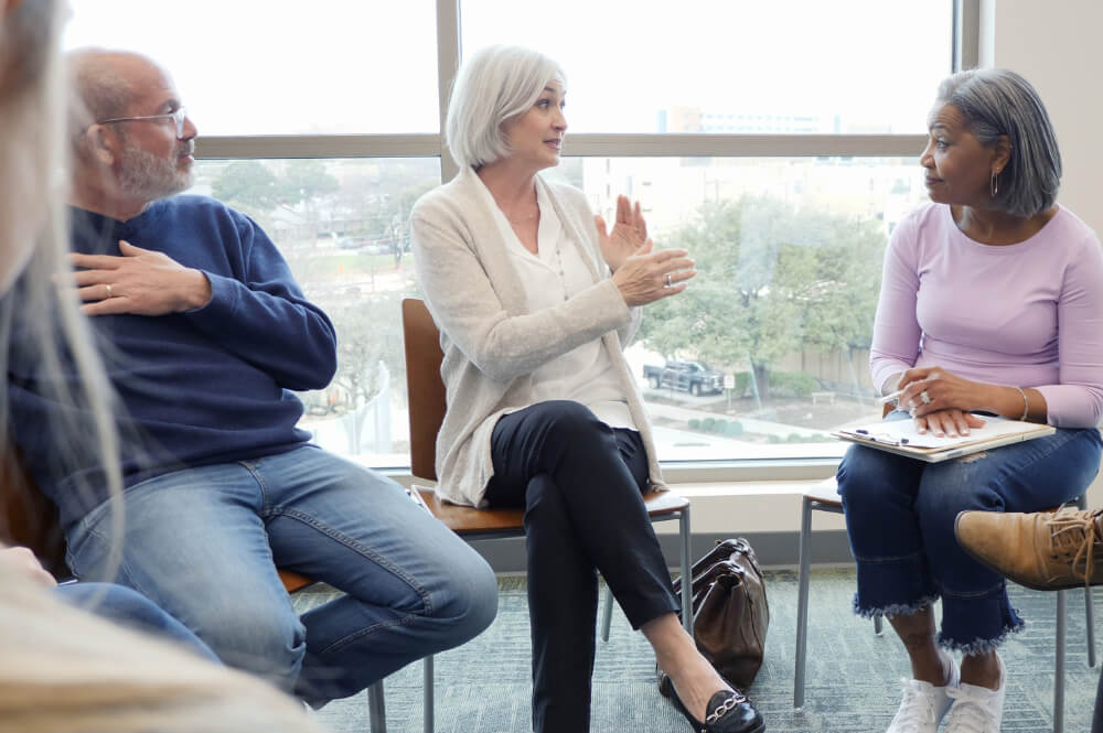 A newly merged team is practicing deep listening during a workshop. True connection starts with listening fully, not just waiting to respond.