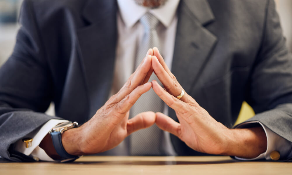 Steepling your hands signals confidence and a deliberate mindset.