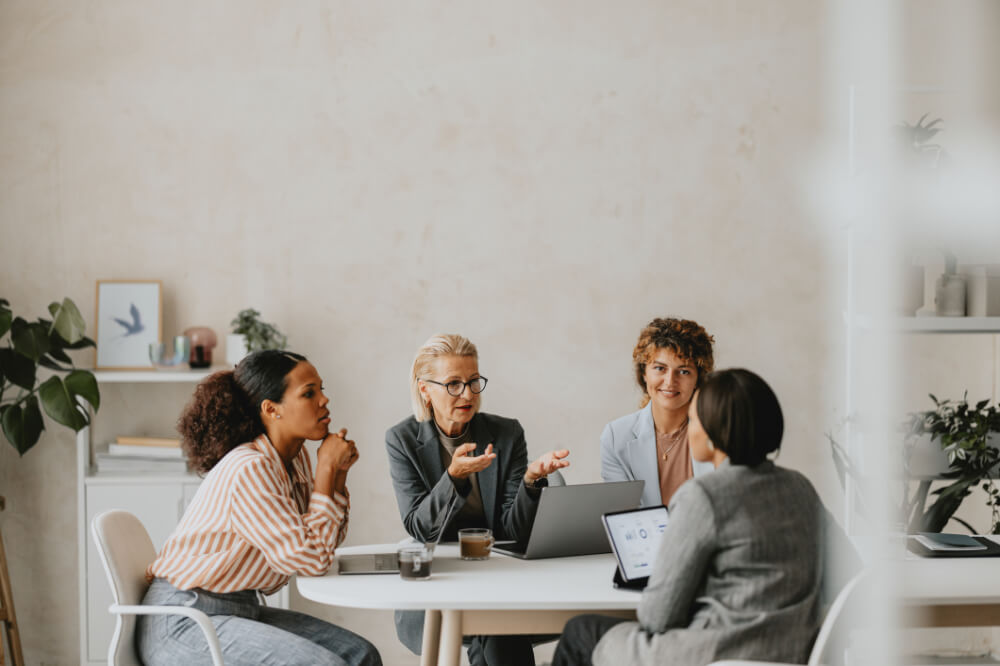 A group of female mentors are guiding their mentee who’s in a challenging situation. Relying on shared wisdom can help navigate difficult decisions with integrity.