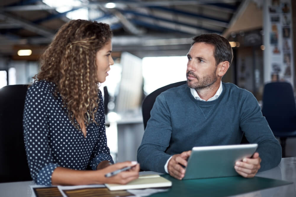 A newly appointed leader is having an honest conversation with her boss about the cultural challenges of her new role. Open dialogue grounded in shared values fosters trust and collaboration.
