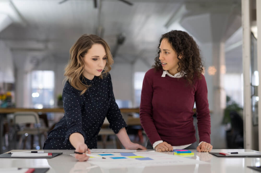 A CMO is collaborating with a staff member on a new campaign. Building trust fosters creativity and ensures a more effective collaboration.