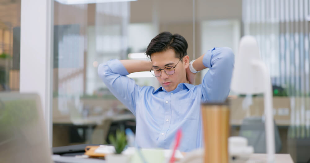 A manager is doing breathing exercises to stay calm in high-pressure situations. Controlled breathing is your secret weapon for staying composed.