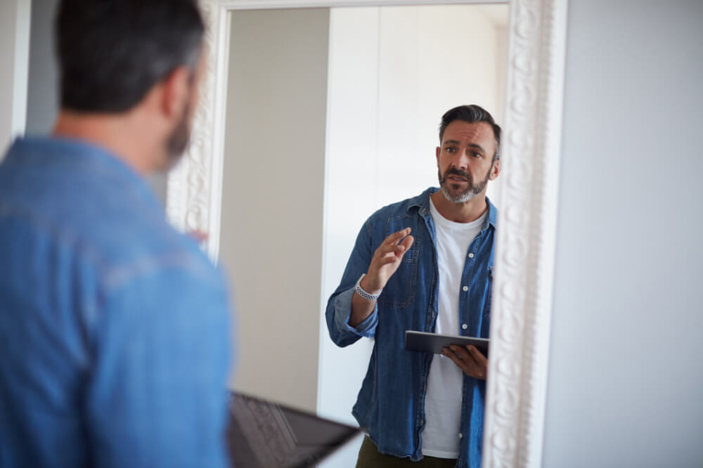 A board member is refining his body language, facial expression and hand movements in front of a mirror. Your presence speaks before your words ever do.