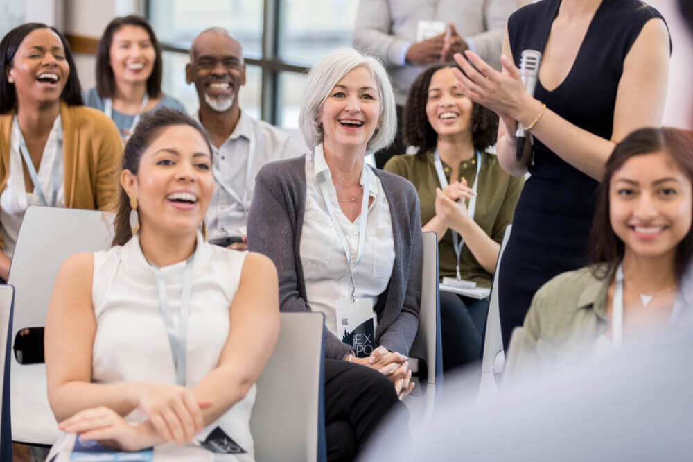 A middle manager is sharing a relevant story with her team members. Consistency in storytelling builds a culture where people feel connected.