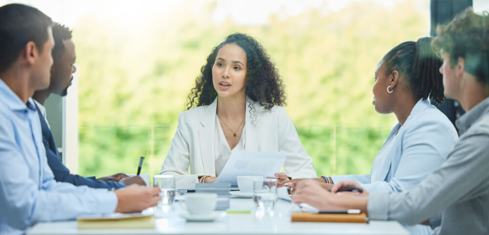 A senior team member is presenting her perspective by telling a personal story. Sharing a piece of yourself builds trust faster than sharing a slide deck.