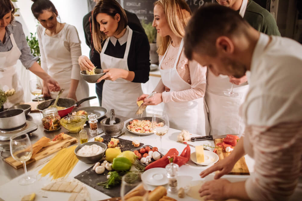 Activities that bring the team together don’t need to be bland. A cooking class can foster communication, collaboration and creativity.